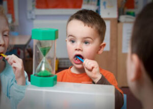 A child brushing teeth at nursery