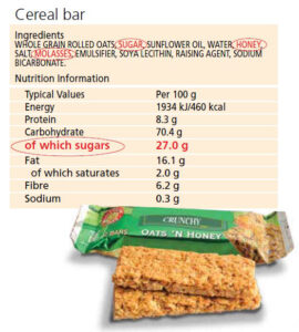 Ingredients and nutritional values of a cereal bar. The cereal bar is sitting at the forefront of the image.
