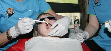 Child undergoing fluoride varnish application